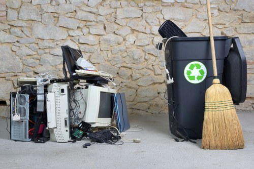 Professionals organizing a cluttered garage during clearance in Finchley
