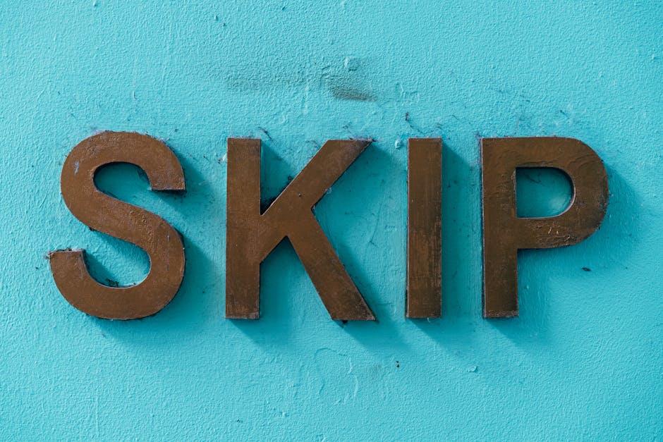 A close-up image of three three-dimensional metallic letters spelling 'SKIP' mounted on a vibrant turquoise painted wall. The letters are made of iron or steel, with a slightly weathered, matte finish